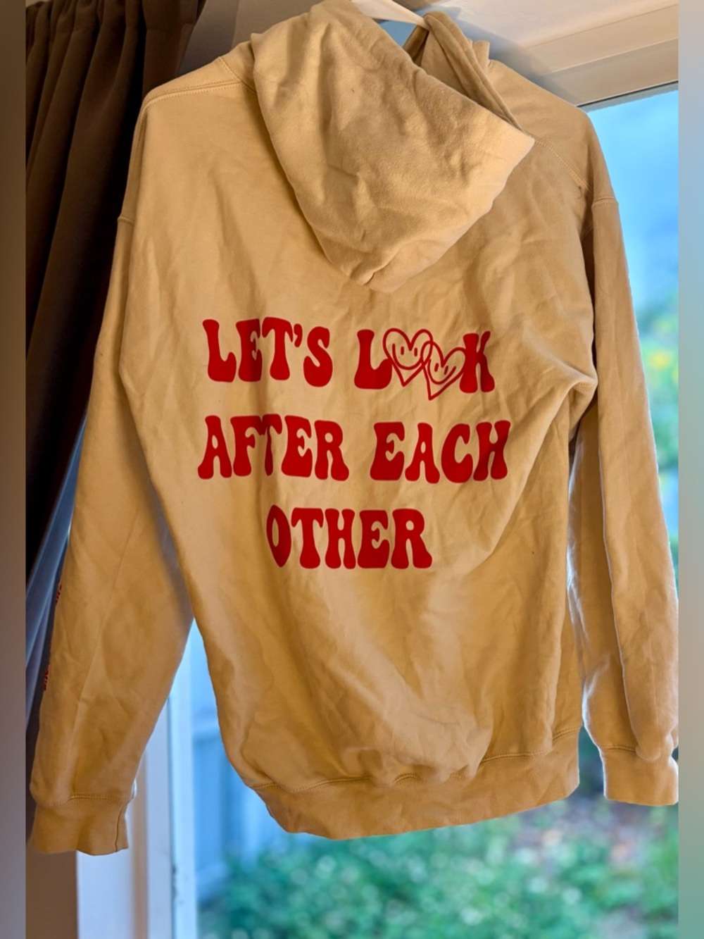 Let’s Look After Each Other” Hoodie – Beige w/ Red Smiley Heart Graphic